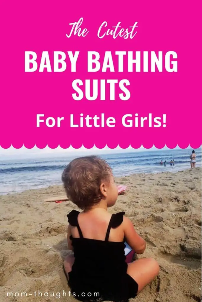 This image has a baby girl sitting on the beach in a black baby bathing suit. The top of the image is hot pink and has white text that says "The Cutest Baby Bathing Suits For Little Girls!"