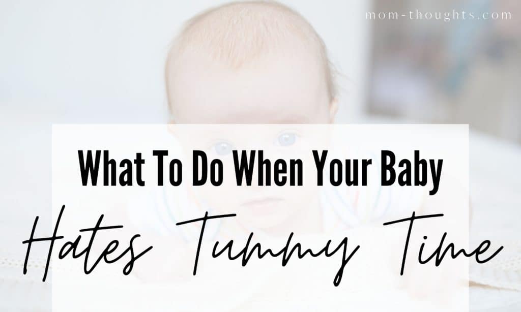 This image is a picture of a baby doing tummy time. There's a faded white box with black text that says "What To Do When Your Baby Hates Tummy Time"