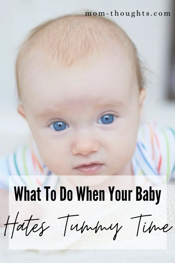 This image is a picture of a baby doing tummy time. There's a faded white box with black text that says "What To Do When Your Baby Hates Tummy Time"