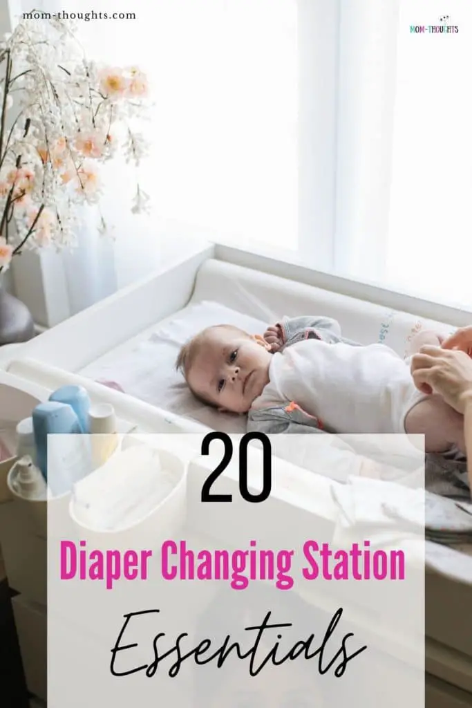 This image shows a mom with a baby on a baby changing table. It has black text that says "20 Diaper Changing Station Essentials"